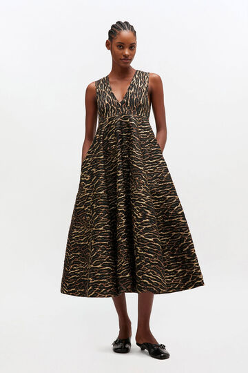 Model wearing long leopard dress with deep v-neck