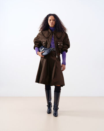 Model wearing brown nylon jacket and skirt