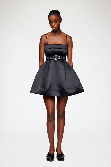 Model wearing short black dress