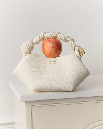 White Bou bag with red apple on the handle