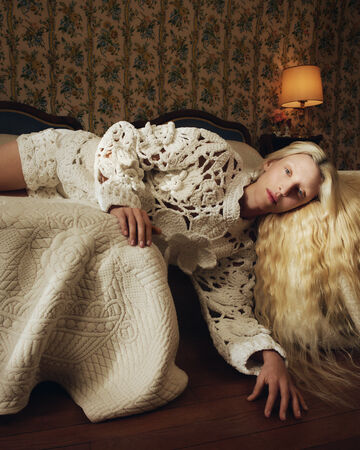 Model wearing white crochet knit