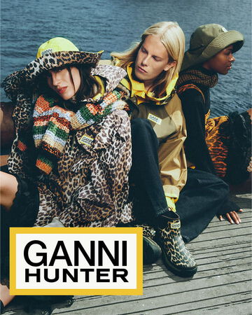 3 models, sitting on dockside, wearing GANNI x Hunter