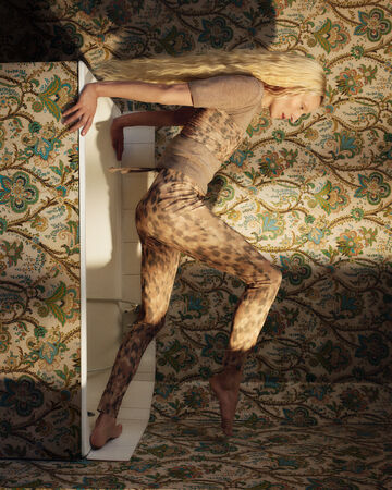 Model wearing leopard outfits on top of a bathtub