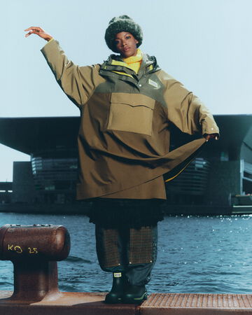 Model wearing GANNI x Hunter poncho