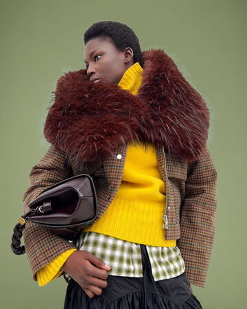 Models wearing yellow knit and big fur collar, holding GANNI Very Bou Bag