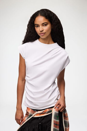 Model wearing white, draped T-shirt