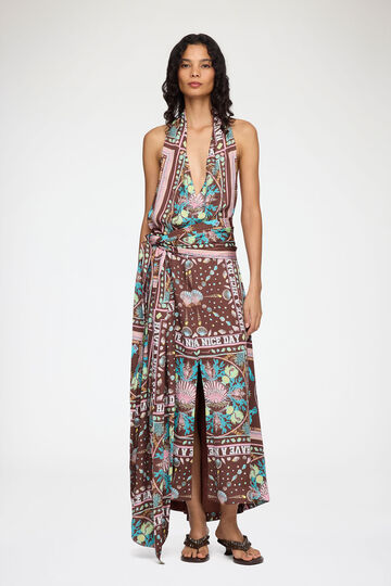 Model wearing long printed halterneck dress
