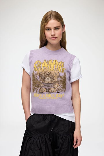 Model wearing graphic knit vest
