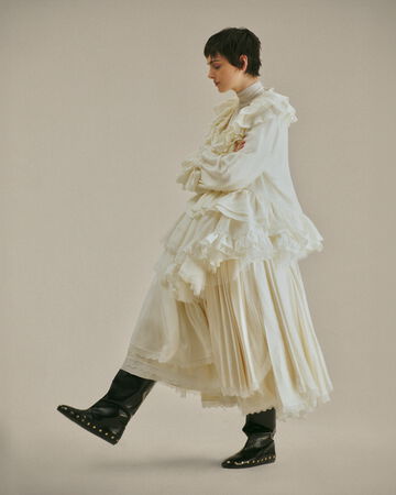 Model wearing white lace dress from the Fall/Winter 2026 collection