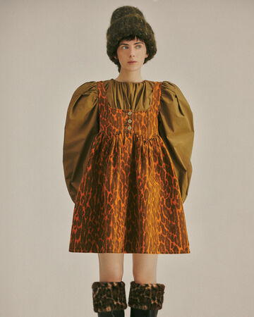 Model wearing a orange check dress from the Fall/Winter 2026 collection